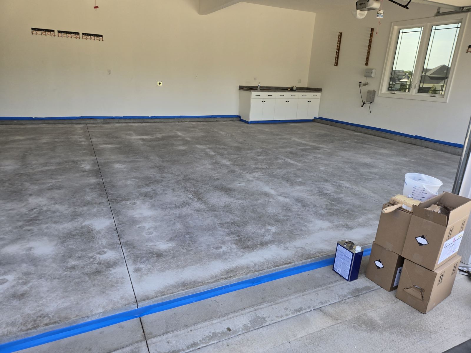Before: bare, stained concrete garage floor